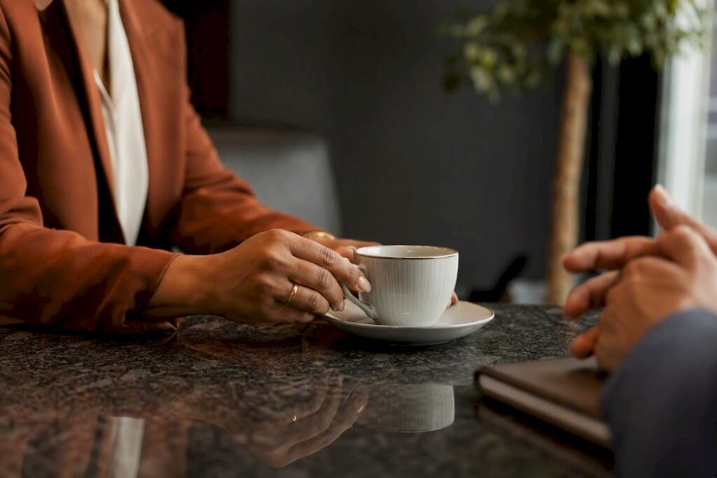 Manager setting coffee cup during coaching session