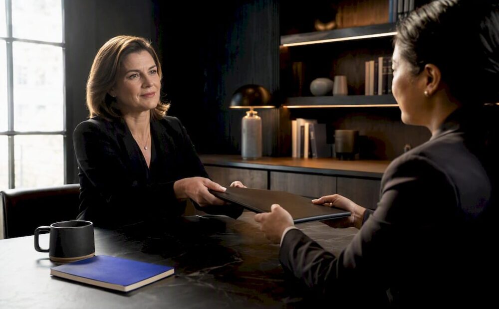 Manager handing colleague a delegated assignment