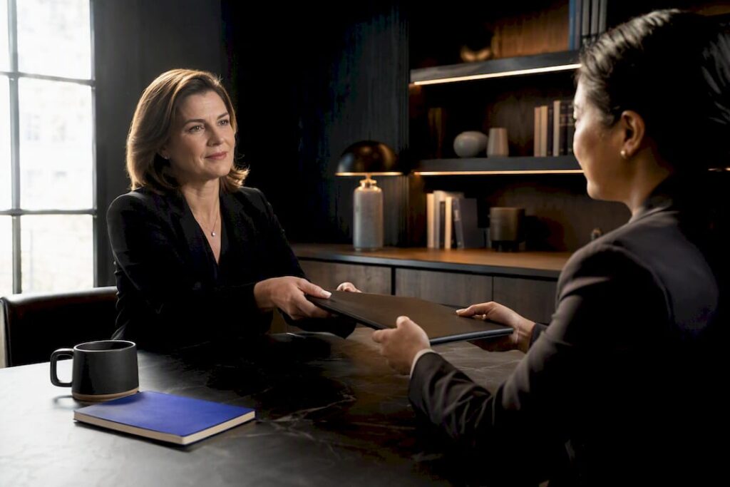 Manager handing colleague a delegated assignment