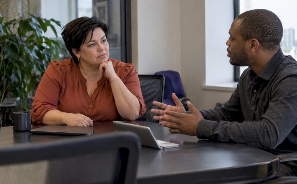 Leader listening as a colleague raises a concern