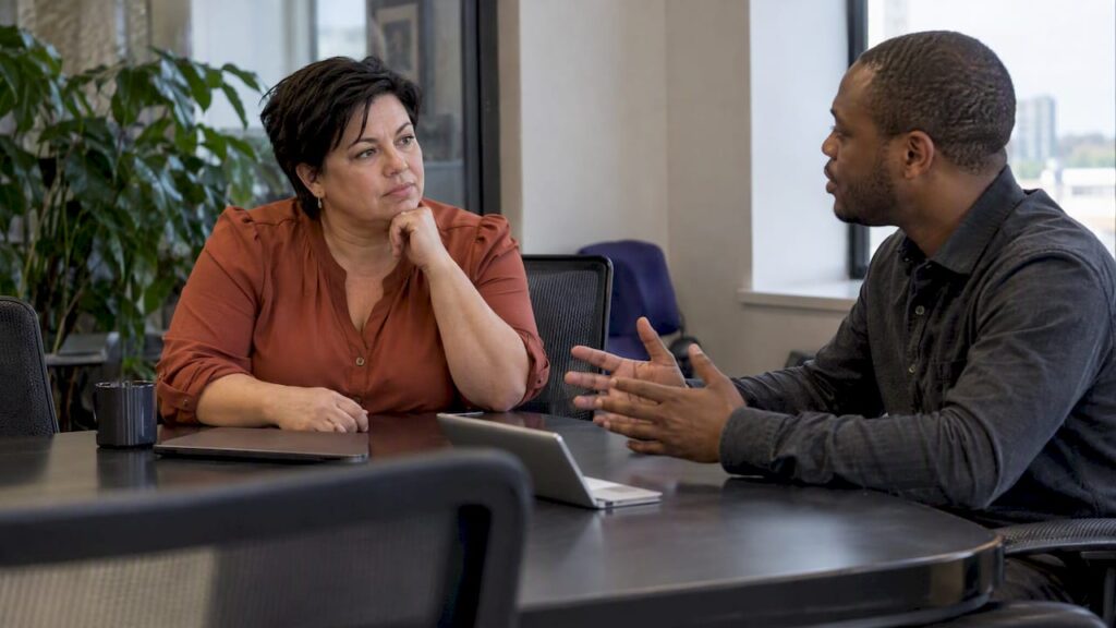 Leader listening as a colleague raises a concern